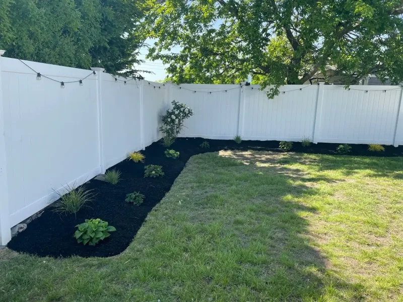 Mulch bed with plantings and string lights